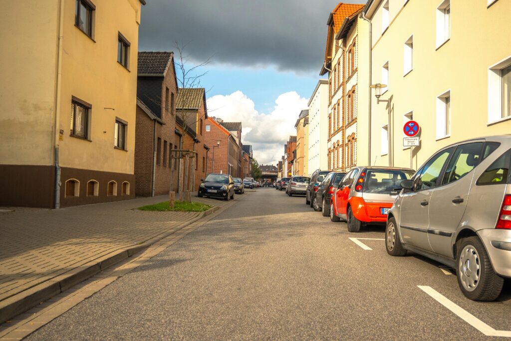 A picturesque street in Lower Saxony, Germany, showcasing classic German architecture and vibrant autumn colors.